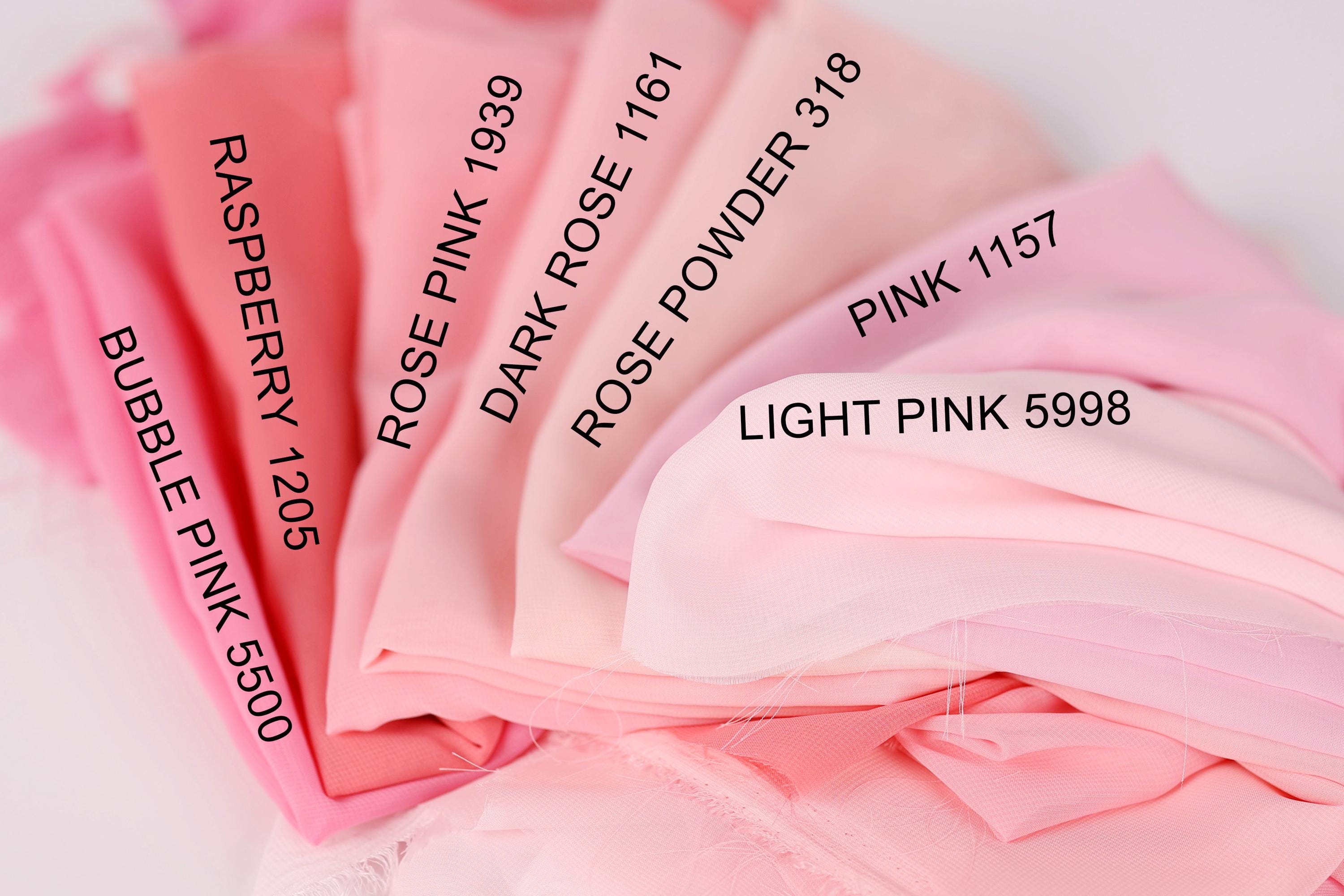 a close-up view of a collection of pink fabric swatches, each with a different shade and label indicating the color.