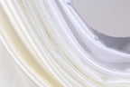 a close up of a white curtain with a white background