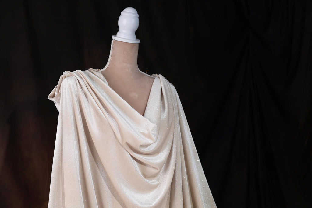 a mannequin wearing a white dress on a black background