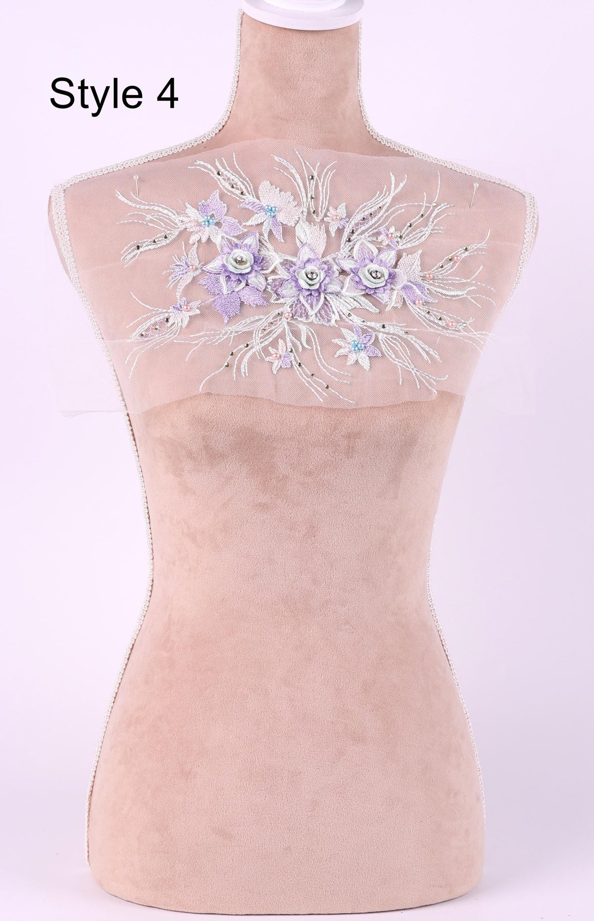 A mannequin with a floral embroidered patch on its back.