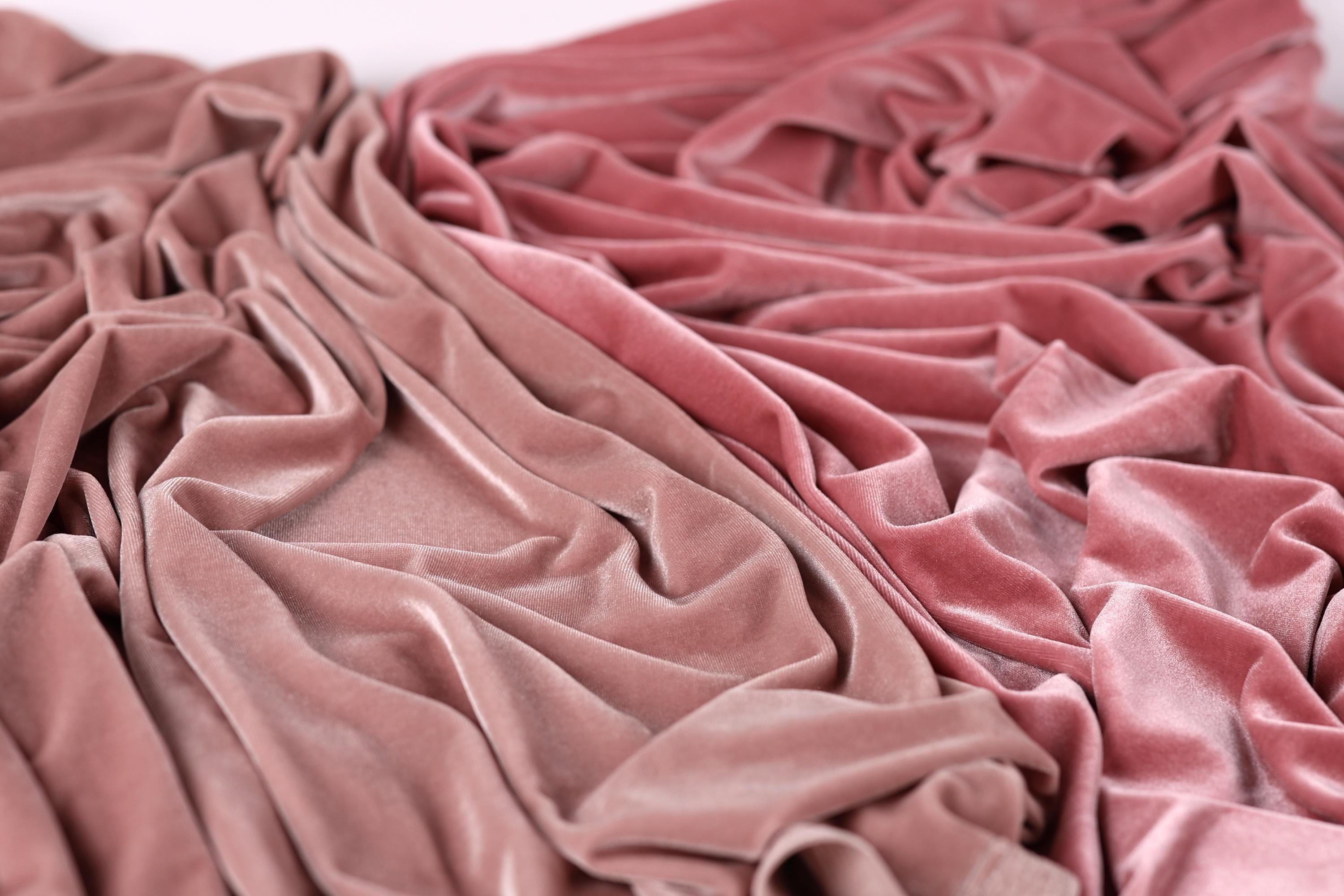 a close-up view of a crumpled fabric with a pinkish-red color.