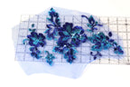 a clear measuring tape with blue sequin flowers placed on it.