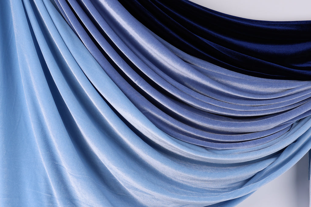 a close-up view of a fabric with a gradient of blue and black colors, creating a visually appealing and textured appearance.