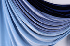 a close-up view of a fabric with a gradient of blue and black colors, creating a visually appealing and textured appearance.