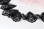a close-up view of a delicate black lace trim with intricate floral patterns.