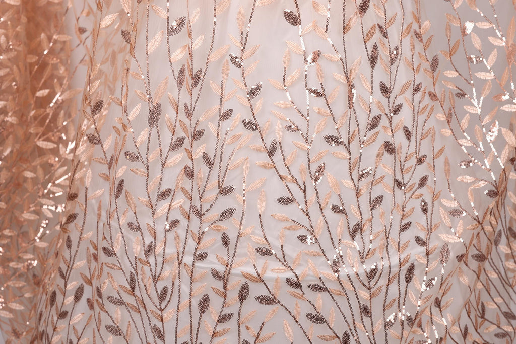 a close-up view of a fabric with a repeating pattern of leaves and branches, creating a textured and visually appealing design.