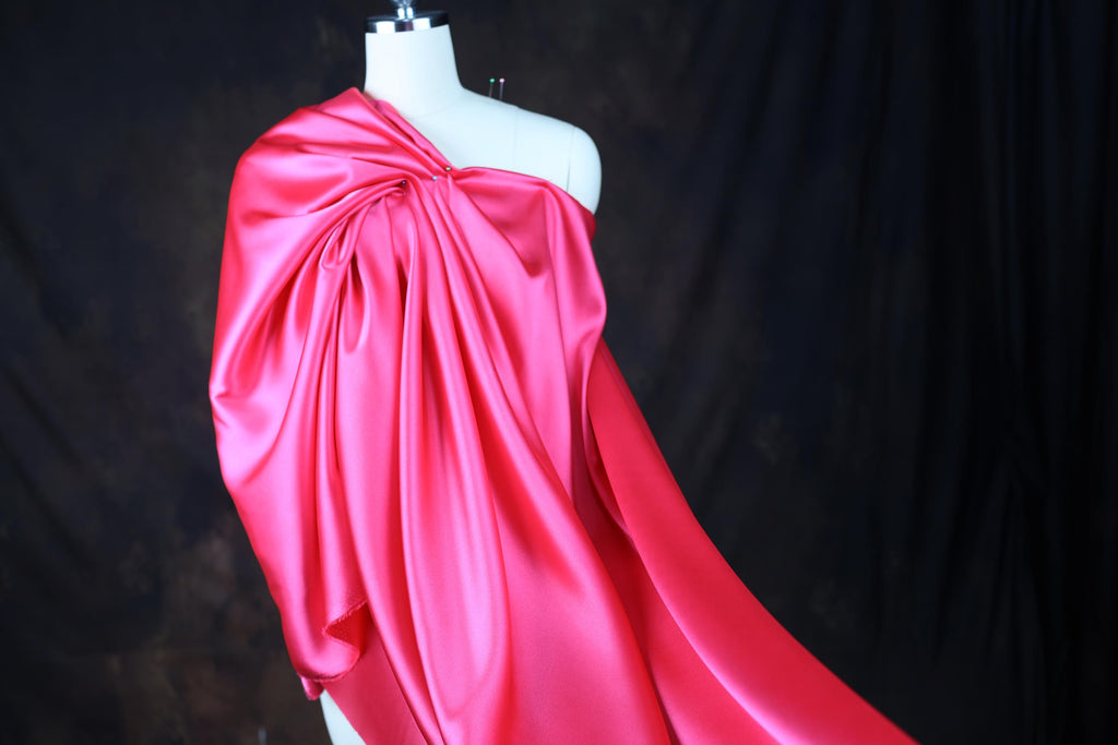 a mannequin dressed in a pink satin dress