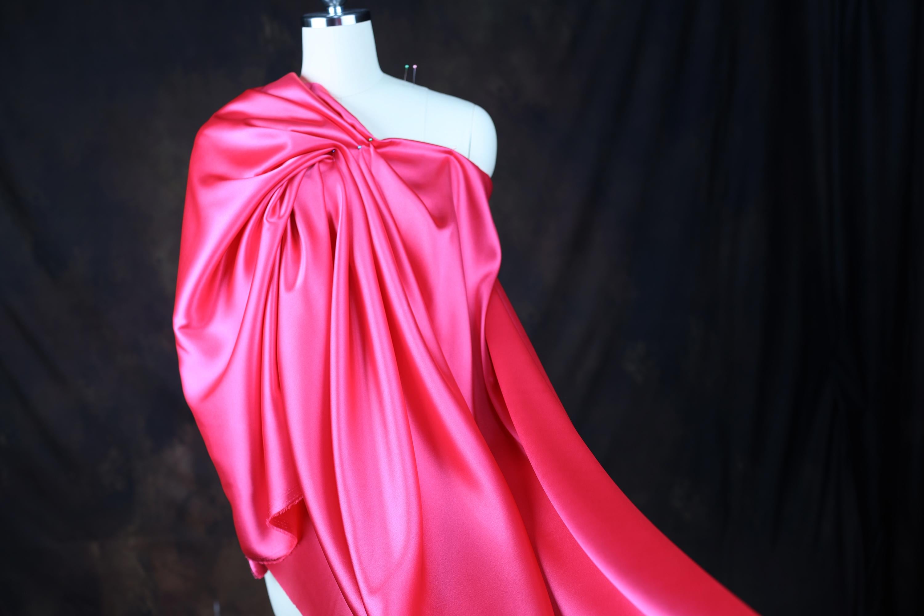 a mannequin dressed in a pink satin dress
