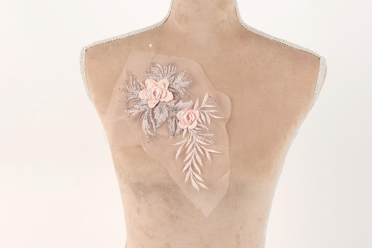 A mannequin with a delicate floral embroidered on its chest.