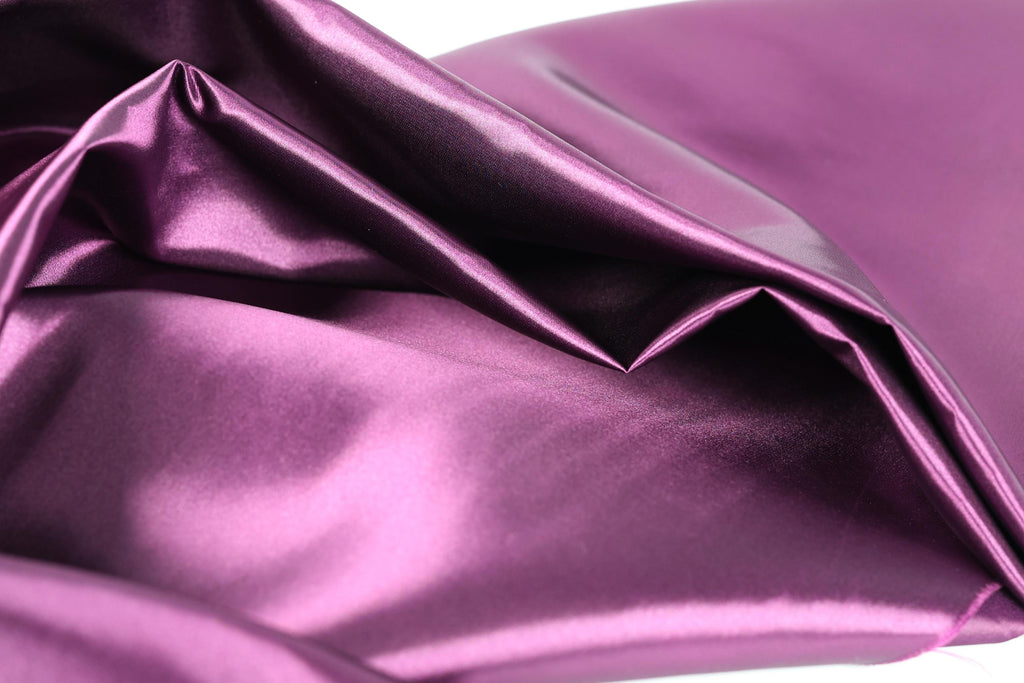 a close-up view of a shiny, purple satin fabric.