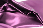 a close-up view of a shiny, purple satin fabric.