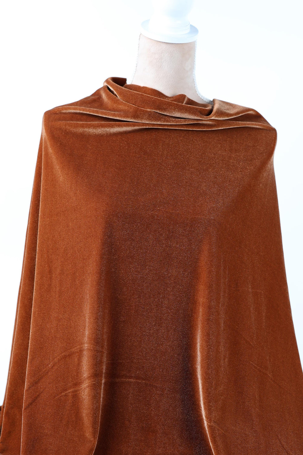 a close-up view of a brown fabric, possibly velvet, with a crumpled appearance.