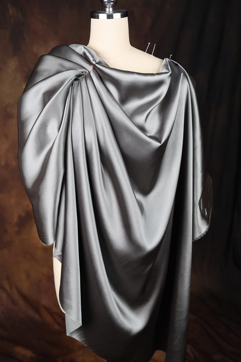 a mannequin with a gray cape on top of it