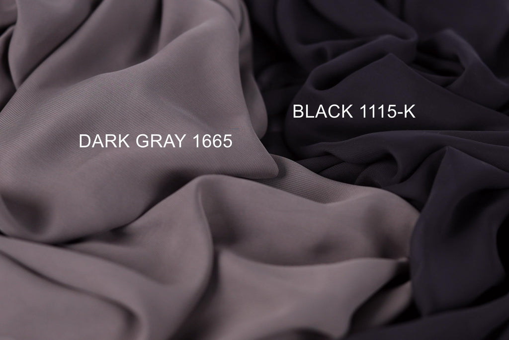 two different fabric swatches, one dark gray and one black, with the dark gray fabric labeled as "Dark Gray 1665" and the black fabric labeled as "Black 1115-K".