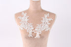 A mannequin with a white lace bodice and floral embroidery on the bust area.