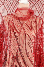 a red sequin dress with a sheer overlay, showcasing a detailed and intricate pattern of red and black sequins.