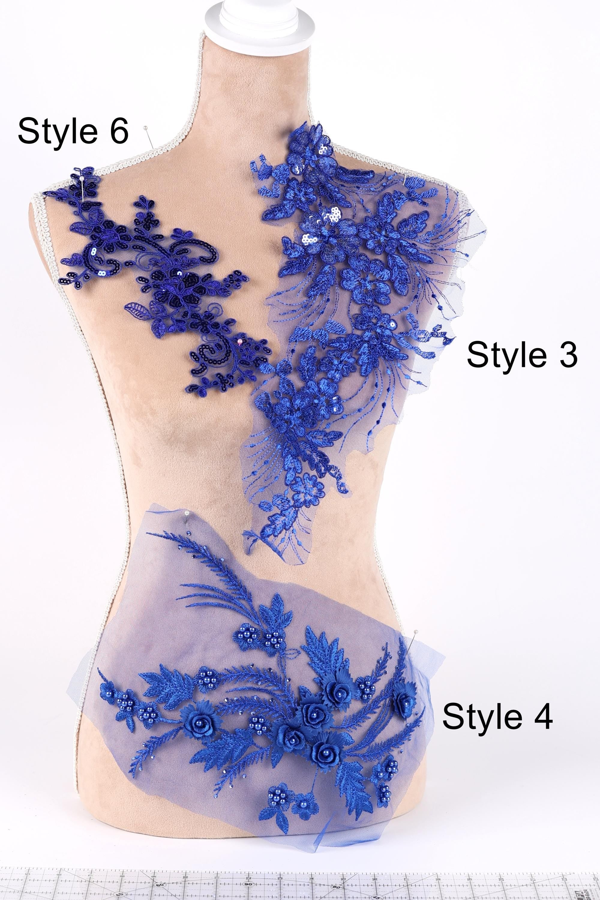 A mannequin with various blue floral and lace designs on its bust and hips, labeled with different styles.