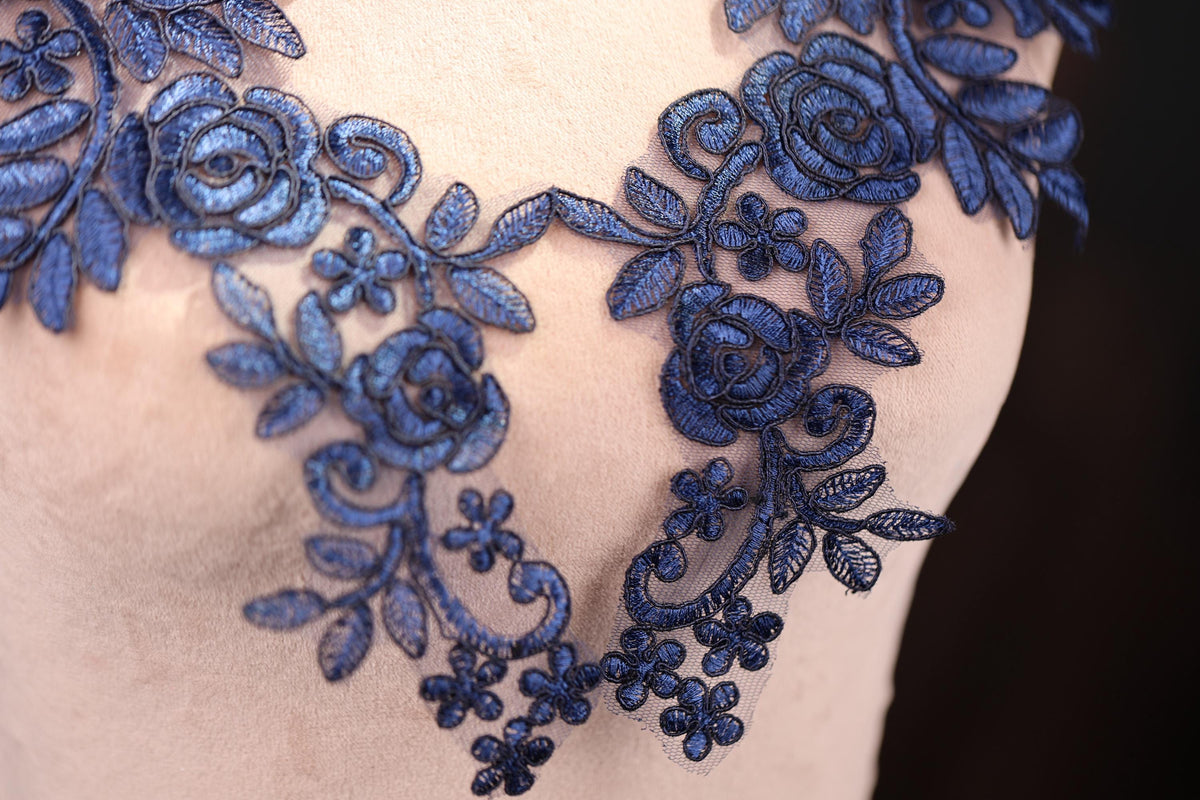 a close up of a dress with blue flowers on it