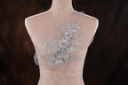 A mannequin with a decorative floral embroidery on its back.