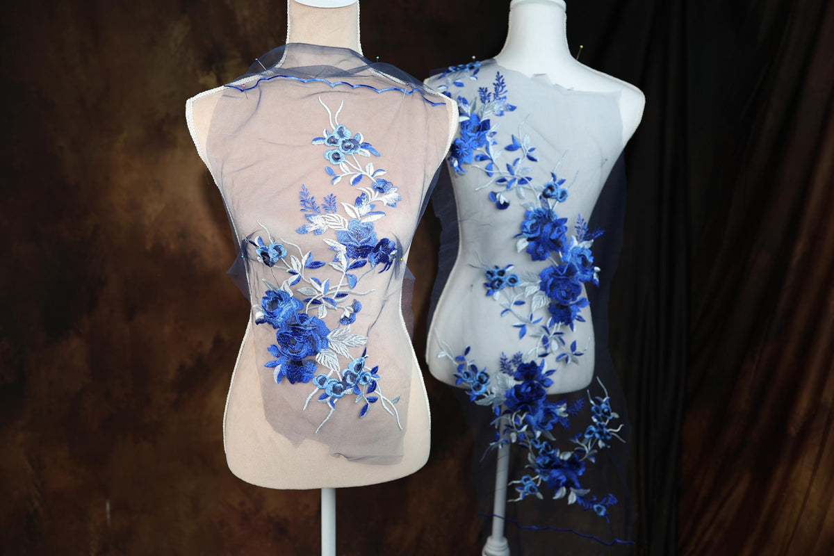 a couple of mannequins with blue flowers on them