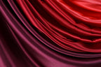 a close-up view of a fabric with a gradient of red and purple colors, creating a visually striking and vibrant appearance.