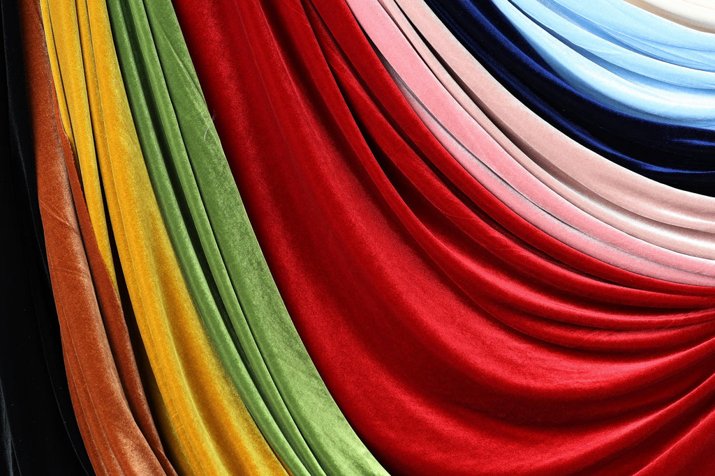 a vibrant display of colorful fabric swatches, including red, green, yellow, and blue, arranged in a visually striking manner.
