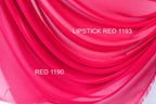 a close-up view of a vibrant red fabric, possibly a sheer or chiffon material. The fabric has a smooth, flowing texture and is displayed in various shades of red, ranging from a bright red to a more muted pink. The image also contains text that reads "LIPSTICK RED 1193" and "RED 1190", possibly indicating the color of the fabric or a reference to the brand or product.