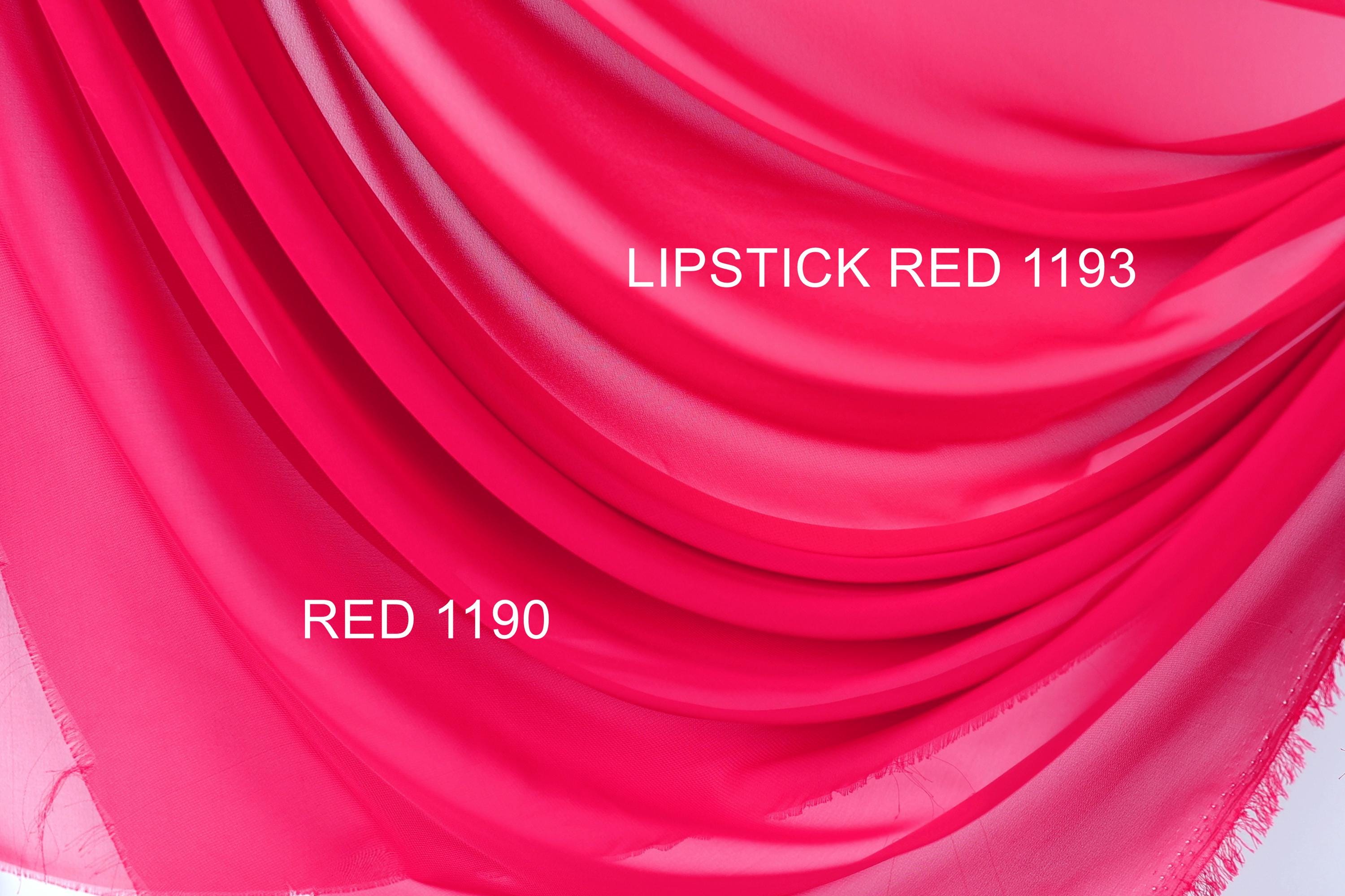 a close-up view of a vibrant red fabric, possibly a sheer or chiffon material. The fabric has a smooth, flowing texture and is displayed in various shades of red, ranging from a bright red to a more muted pink. The image also contains text that reads "LIPSTICK RED 1193" and "RED 1190", possibly indicating the color of the fabric or a reference to the brand or product.