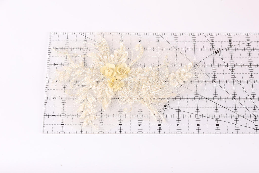 a clear ruler with a floral design on it, placed on a white surface.
