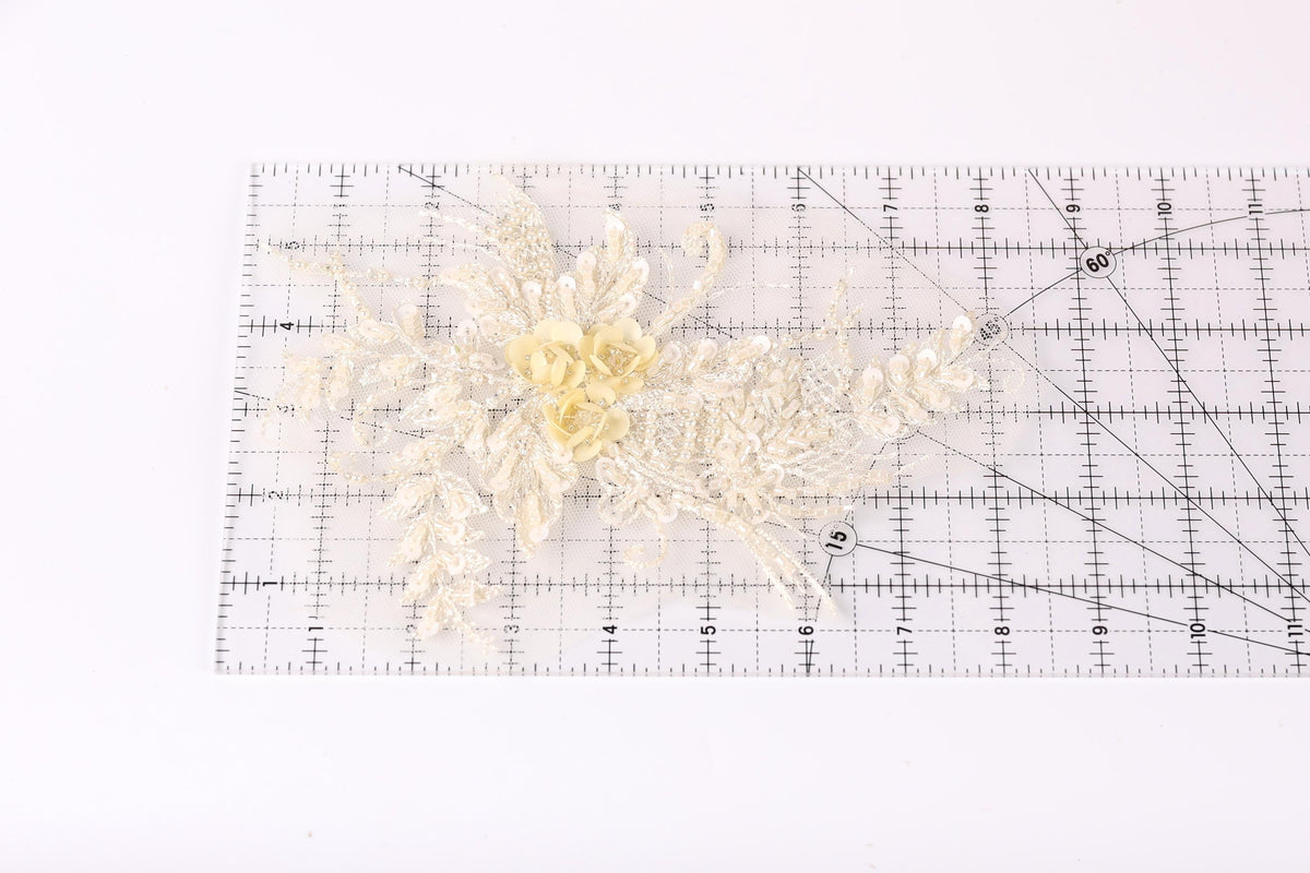 a clear ruler with a floral design on it, placed on a white surface.