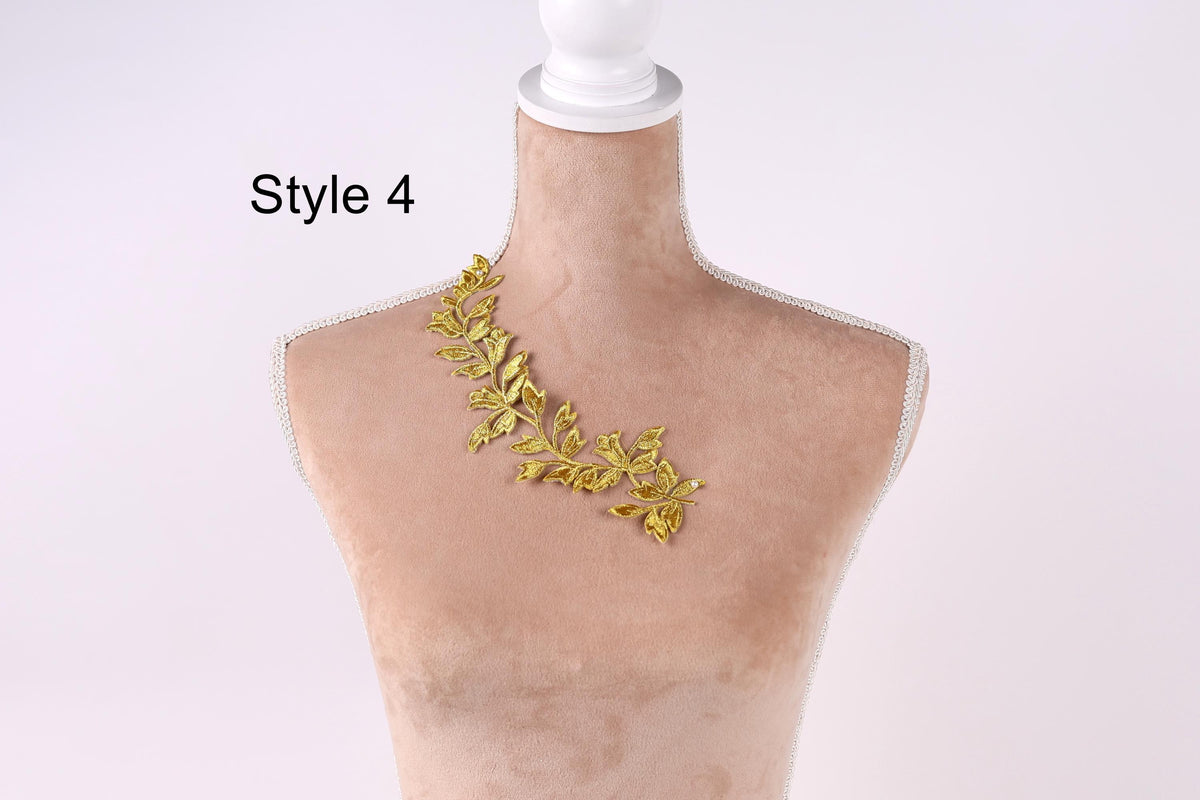 A mannequin wearing a gold leaf necklace with a floral design.