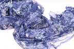 a close-up view of a piece of blue fabric with a floral pattern, featuring a mix of blue and white colors.