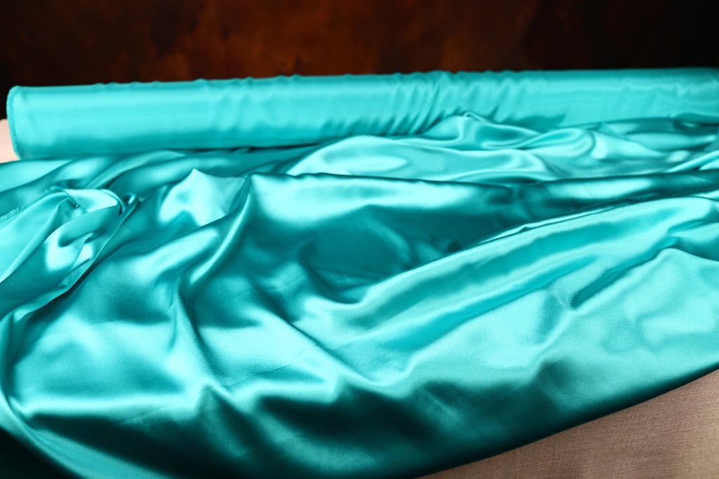 a close up of a piece of cloth on a bed