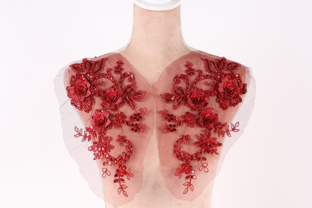 A mannequin with red floral embroidery on its shoulders.