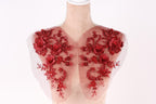A mannequin with red floral embroidery on its shoulders.