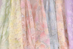 a variety of colorful, patterned fabric swatches, showcasing different textures and designs.