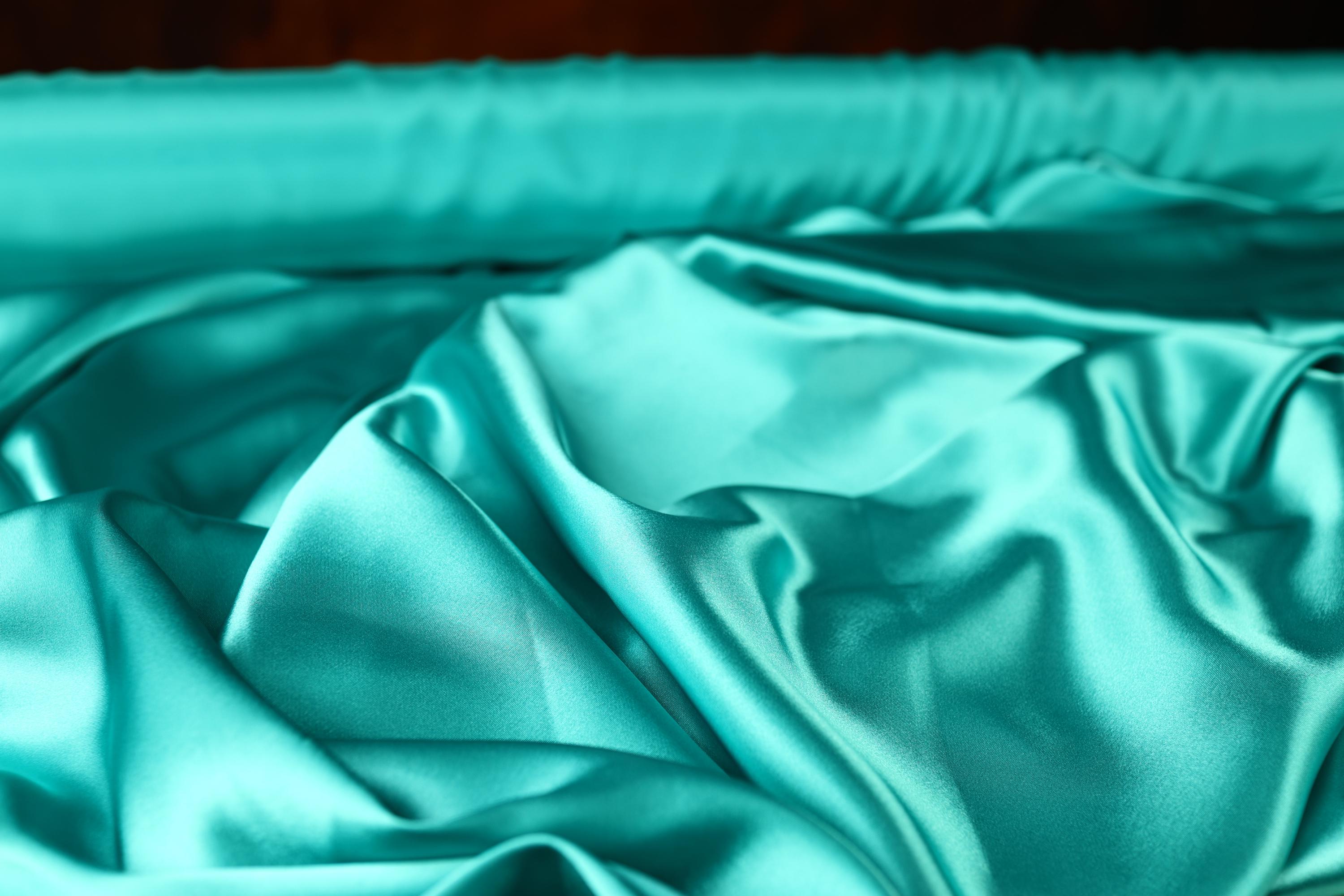 a close up of a blue satin material