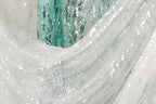 a close-up view of a white fabric with sequin patterns, creating a visually striking and intricate design.