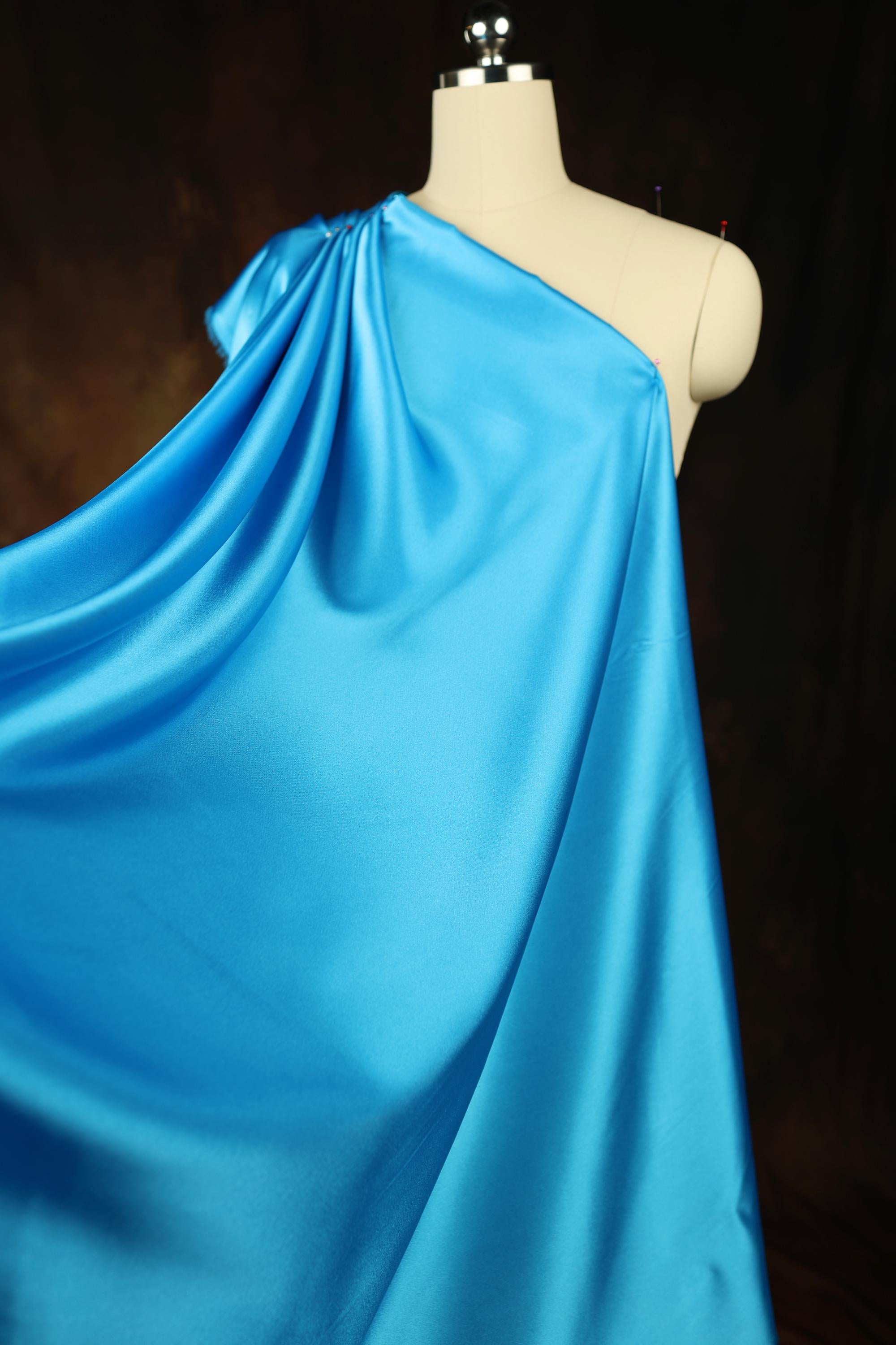 a mannequin is dressed in a blue dress