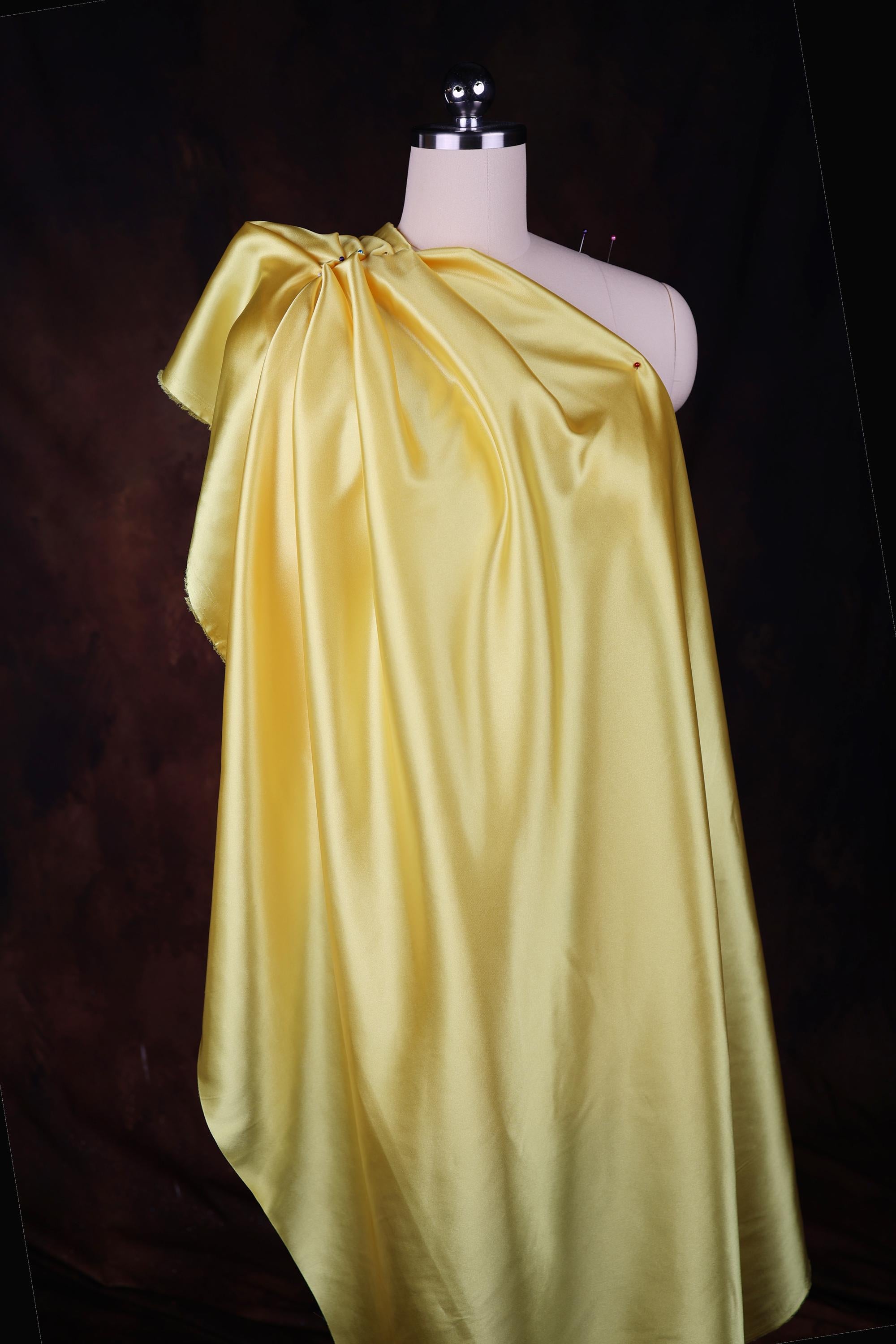 a mannequin dressed in a yellow cape