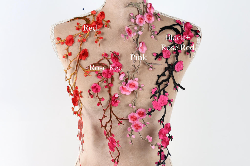 a mannequin with a variety of floral designs on its torso, including red, black, pink, and rose red flowers.