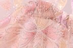 a close-up view of a delicate, intricately designed fabric with a floral pattern. The fabric appears to be made of sheer material, giving it a soft and delicate appearance. The floral pattern is composed of numerous small, colorful beads or sequins that add a vibrant touch to the overall design. The image does not contain any text or other discernible objects, and the focus is solely on the intricate details of the fabric.