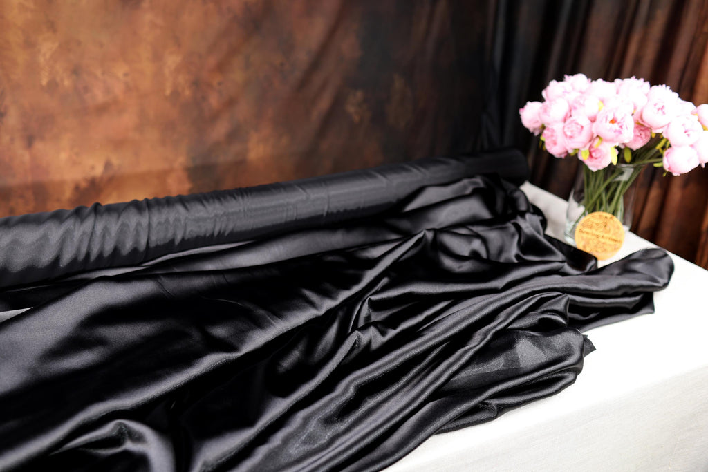 a vase filled with pink flowers sitting on top of a table