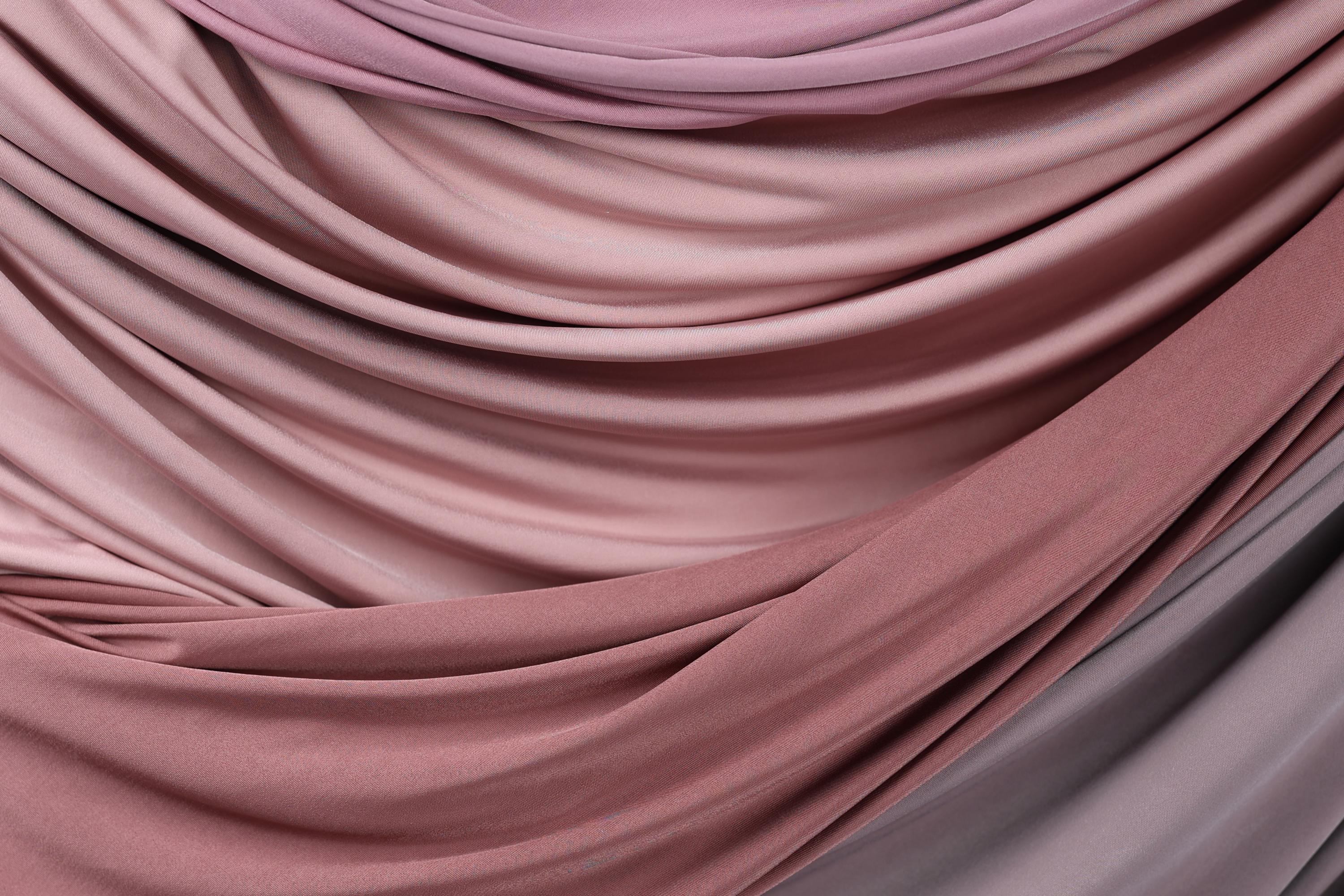 a close-up view of a fabric with a gradient of pink and purple colors, creating a visually appealing and textured appearance.
