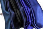 a close-up view of a collection of fabric swatches in various shades of blue, including navy, royal blue, and dark blue.
