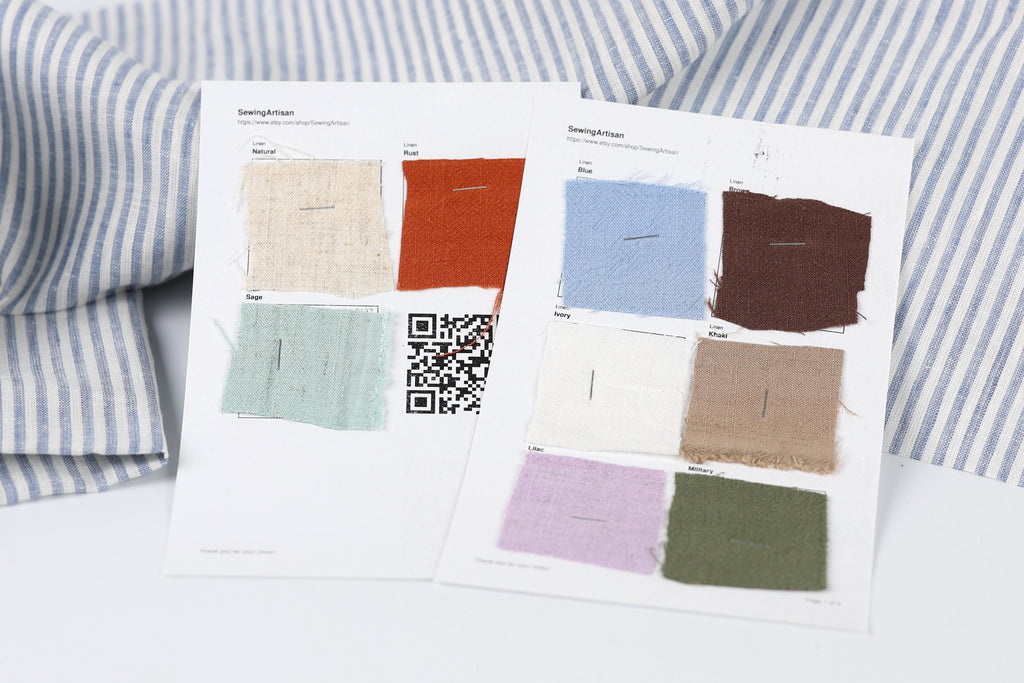 two pieces of paper with fabric swatches and QR codes, placed on a white surface.