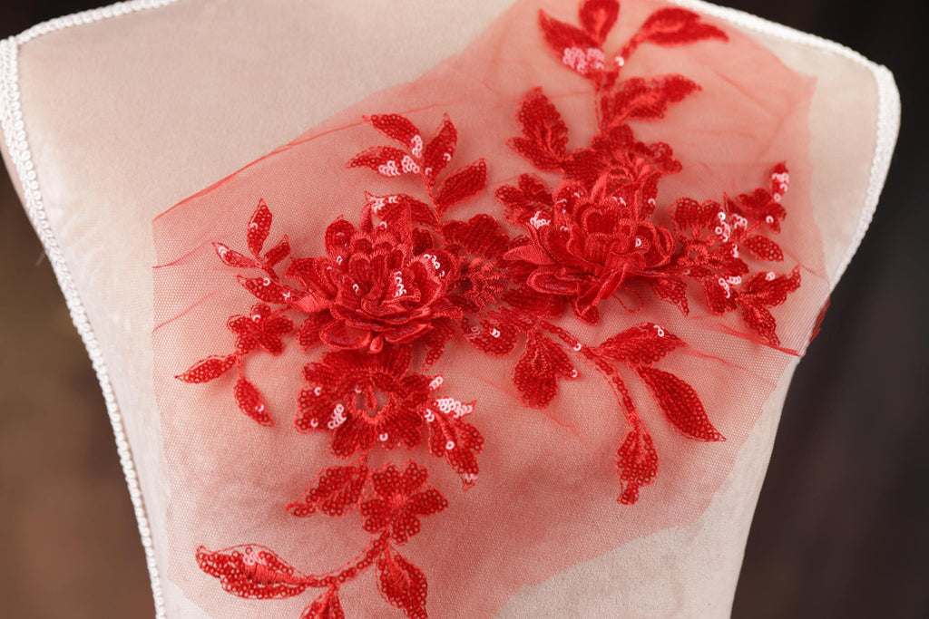 a piece of cloth with red flowers on it