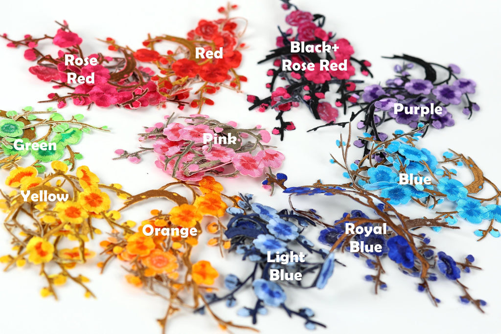 A collection of colorful artificial flowers, each with a different color and labeled with the corresponding color name.