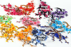 A collection of colorful artificial flowers, each with a different color and labeled with the corresponding color name.