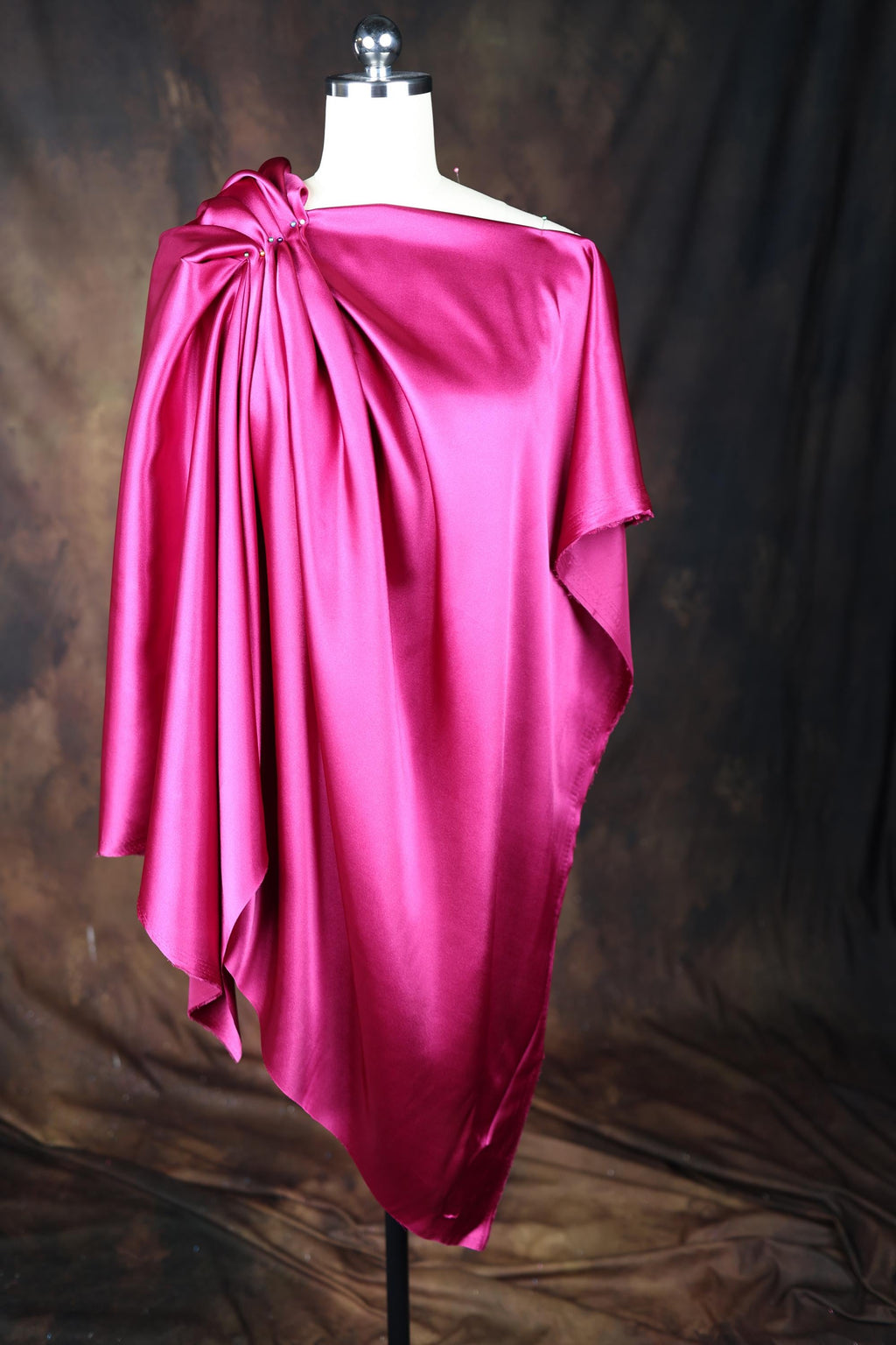 a pink dress on a mannequin on a black background